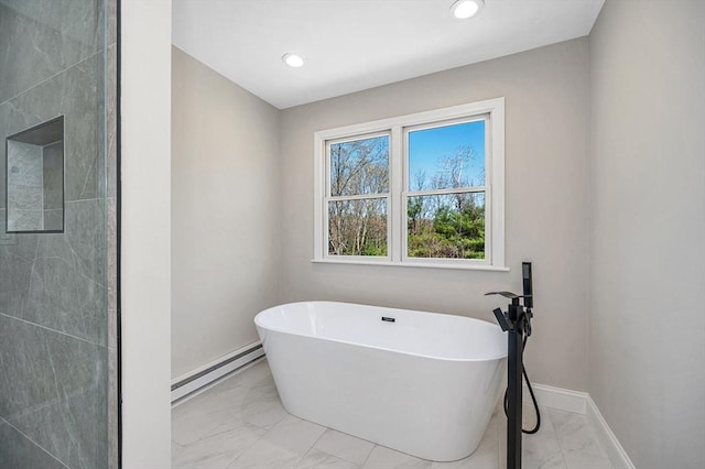 bathroom featuring a freestanding bath, marble finish floor, recessed lighting, baseboards, and a baseboard radiator