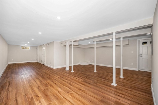 below grade area with recessed lighting, light wood-style floors, and baseboards
