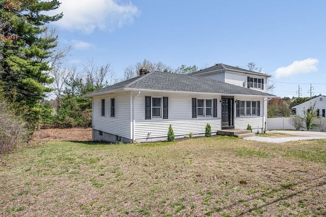 bungalow-style house featuring a shingled roof, a front lawn, fence, and a chimney