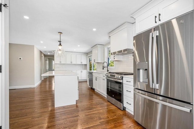kitchen with dark wood-type flooring, light countertops, tasteful backsplash, a sink, and appliances with stainless steel finishes