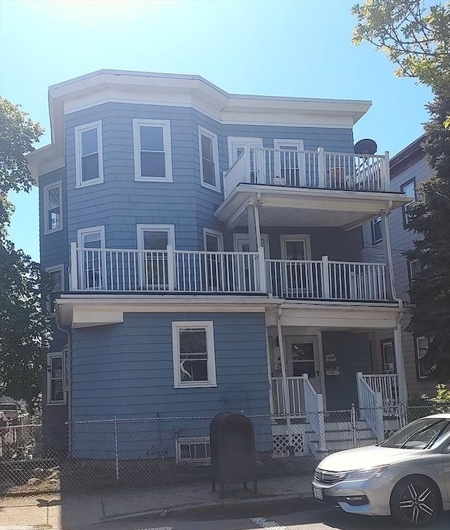 61-63 Grant St, Somerville, MA 02145 - view of front of property with a balcony and fence