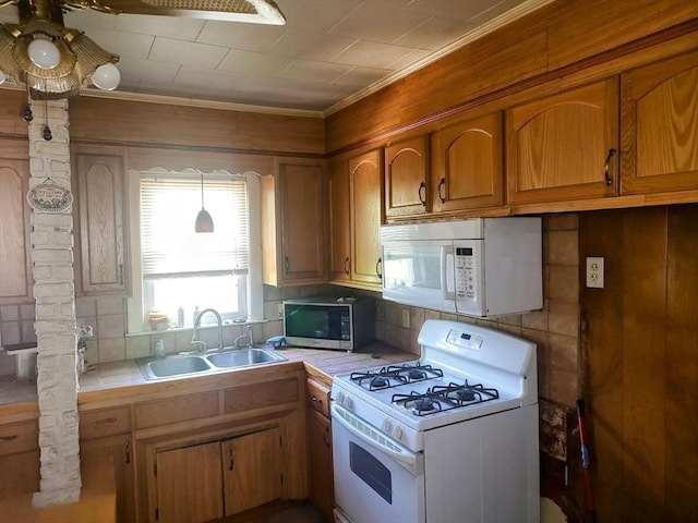 61-63 Grant St, Somerville, MA 02145 - kitchen with white appliances, a sink, tile countertops, brown cabinetry, and crown molding