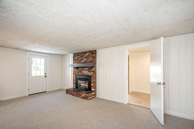12 Beverly Cir, Randolph, MA 02368 - unfurnished living room with a textured ceiling, carpet, a fireplace, and baseboards
