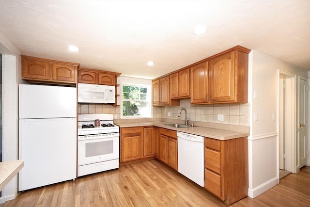 12 Beverly Cir, Randolph, MA 02368 - kitchen featuring white appliances, a sink, light wood-style flooring, light countertops, and tasteful backsplash
