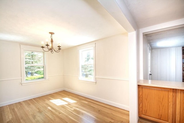 12 Beverly Cir, Randolph, MA 02368 - spare room featuring light wood-style floors, baseboards, and a chandelier