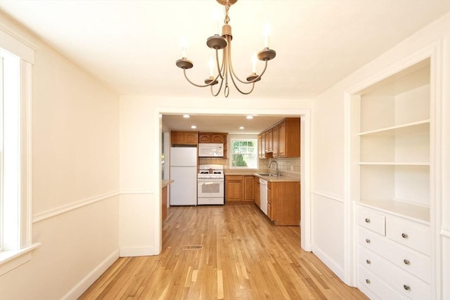 12 Beverly Cir, Randolph, MA 02368 - kitchen featuring white appliances, a sink, light wood finished floors, a chandelier, and light countertops