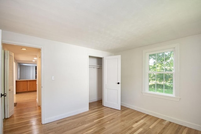 12 Beverly Cir, Randolph, MA 02368 - unfurnished bedroom featuring baseboards, light wood-style floors, and a closet