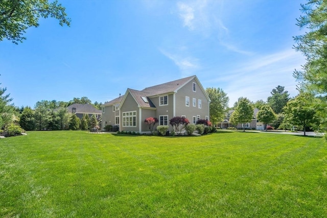 27 Covered Bridge Ln, Wayland, MA 01778 - rear view of house featuring a yard