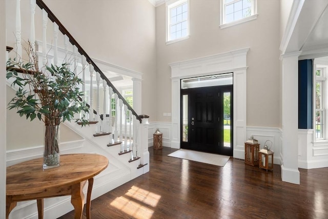 27 Covered Bridge Ln, Wayland, MA 01778 - entryway featuring a decorative wall, stairs, wainscoting, wood finished floors, and a high ceiling