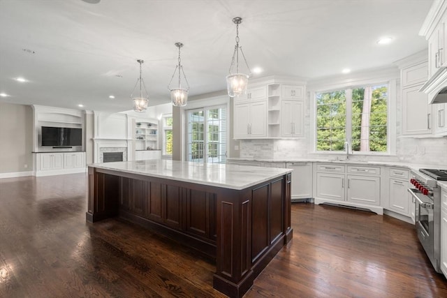 27 Covered Bridge Ln, Wayland, MA 01778 - kitchen featuring high end stainless steel range oven, a sink, open floor plan, decorative backsplash, and a kitchen island