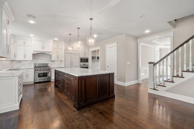 27 Covered Bridge Ln, Wayland, MA 01778 - kitchen with stainless steel appliances, white cabinets, dark brown cabinets, baseboards, and recessed lighting