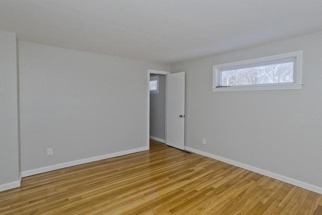 unfurnished room with light wood-type flooring