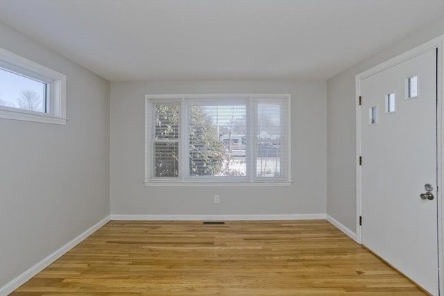 unfurnished room with light hardwood / wood-style flooring