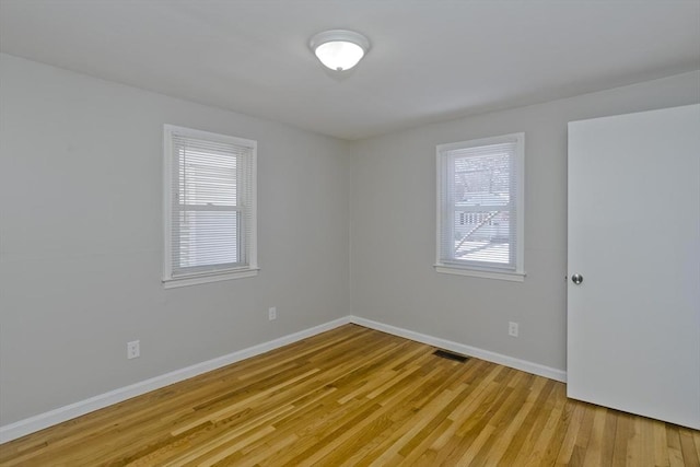 unfurnished room with light wood-type flooring