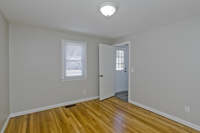 unfurnished room featuring hardwood / wood-style floors