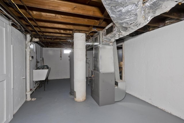 basement with heating unit and sink