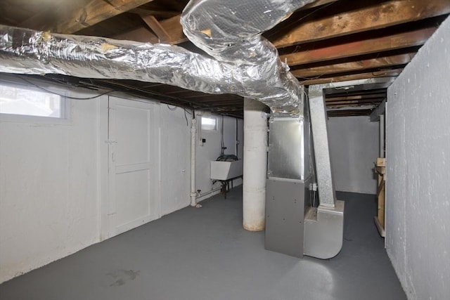 basement with sink and heating unit