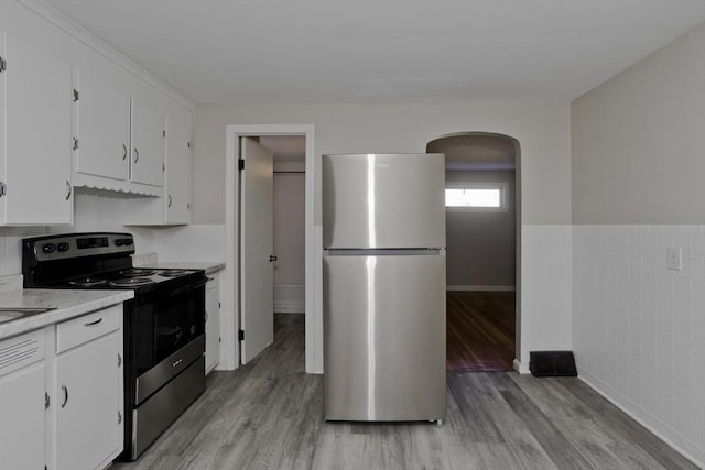 kitchen featuring white cabinetry, stainless steel appliances, and light wood-type flooring