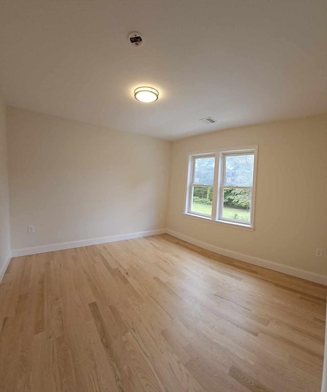 spare room with light hardwood / wood-style floors