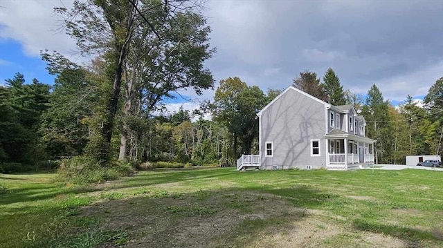 view of home's exterior featuring a porch and a yard