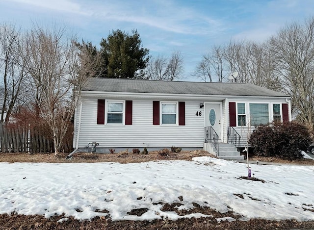 view of front of home featuring fence