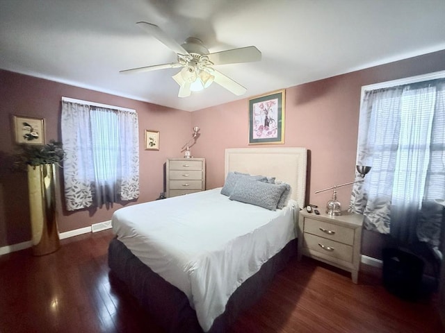 bedroom featuring ceiling fan, baseboards, and dark wood-type flooring