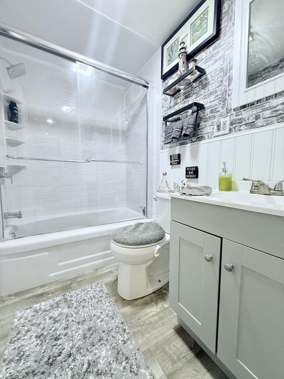 bathroom with shower / bathing tub combination, vanity, and toilet