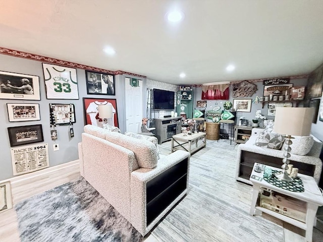 living area featuring wood finished floors and recessed lighting