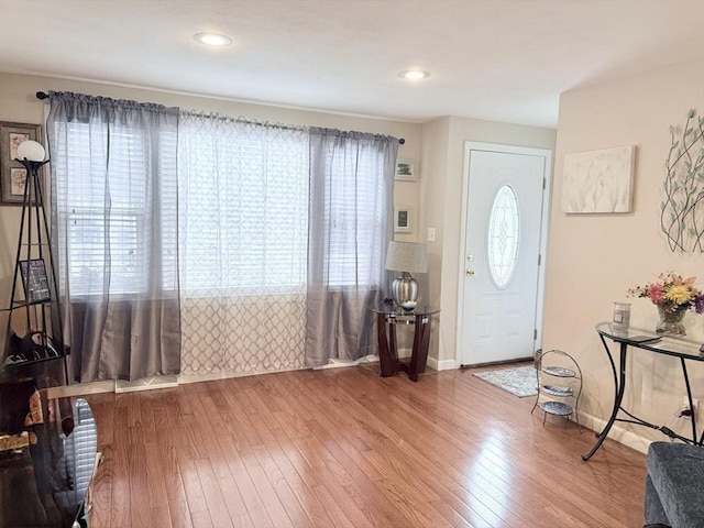 foyer entrance with recessed lighting, baseboards, and hardwood / wood-style floors