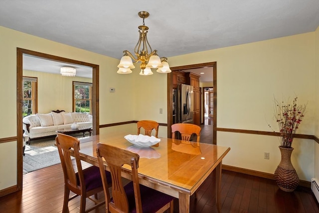 dining room featuring dark wood-style flooring, a chandelier, baseboards, and a baseboard radiator