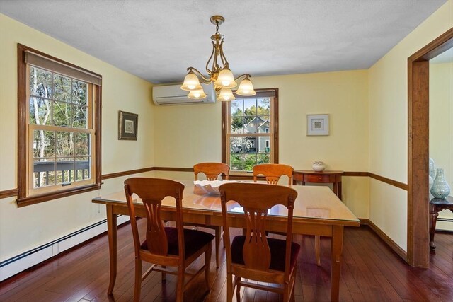 dining space featuring a wall unit AC, a baseboard heating unit, hardwood / wood-style floors, a chandelier, and baseboards