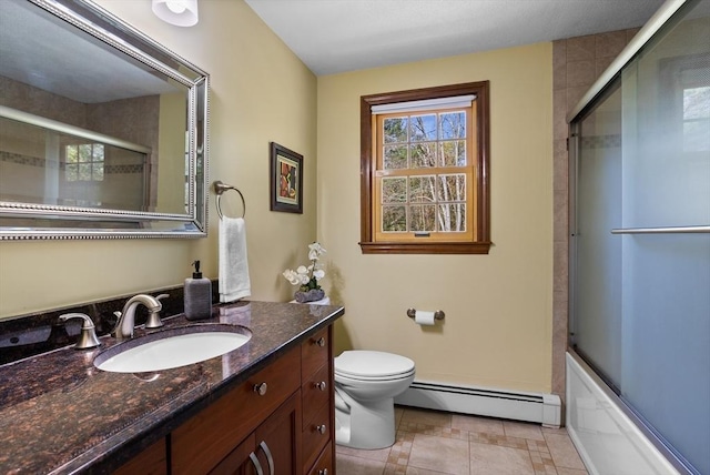 bathroom featuring a baseboard radiator, toilet, vanity, and shower / bath combination with glass door