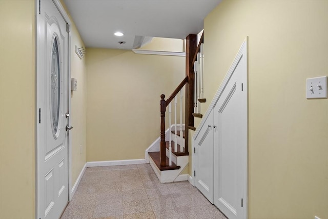 entrance foyer with baseboards, stairway, and recessed lighting