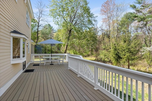 wooden terrace featuring outdoor dining space