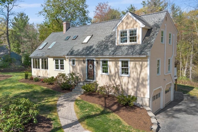 cape cod-style house featuring an attached garage, a chimney, driveway, a front lawn, and roof with shingles