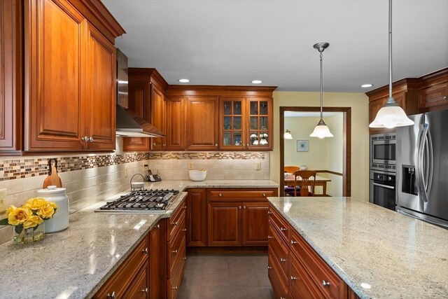 kitchen with stainless steel appliances, backsplash, light stone counters, glass insert cabinets, and recessed lighting