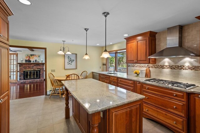 kitchen with wall chimney exhaust hood, stainless steel appliances, decorative backsplash, a baseboard heating unit, and recessed lighting