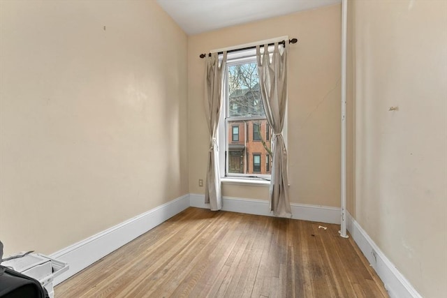 unfurnished room featuring hardwood / wood-style flooring