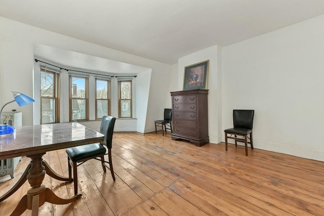 home office with light hardwood / wood-style floors