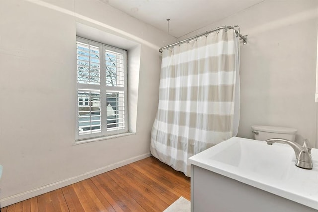 bathroom featuring sink, toilet, and wood-type flooring