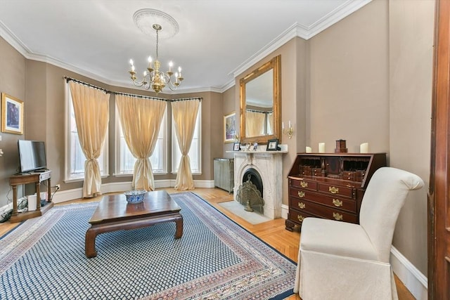 living area featuring ornamental molding and an inviting chandelier