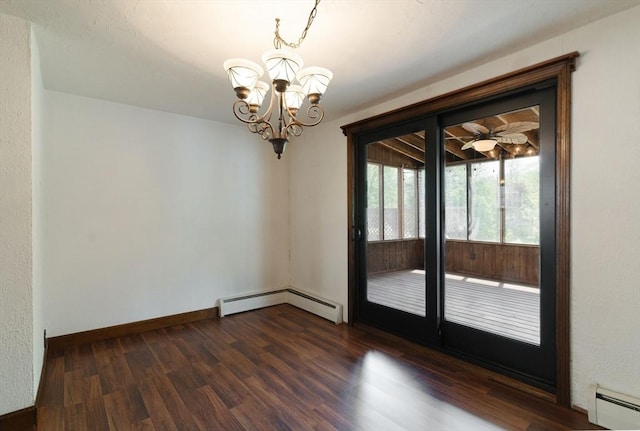 spare room featuring a baseboard heating unit, a chandelier, dark wood finished floors, and baseboards
