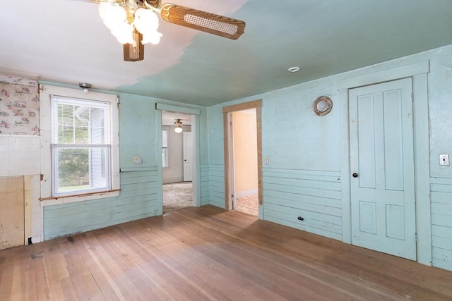 unfurnished bedroom featuring hardwood / wood-style flooring and a ceiling fan