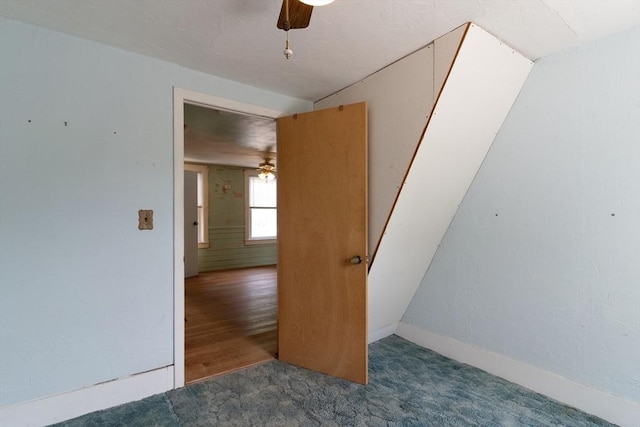 spare room with a ceiling fan, carpet, and baseboards