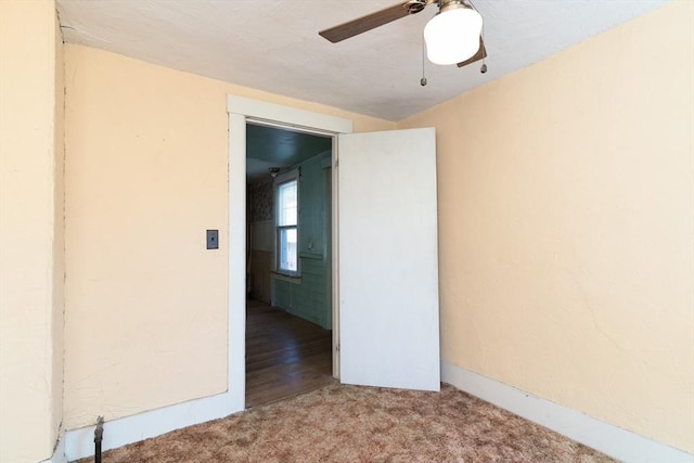 spare room featuring carpet and a ceiling fan
