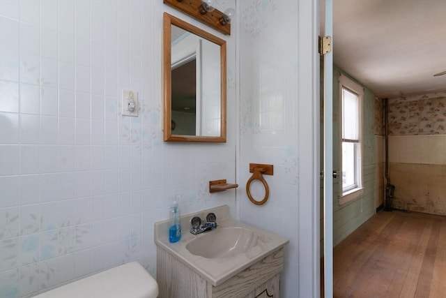 bathroom with wood-type flooring, vanity, and toilet