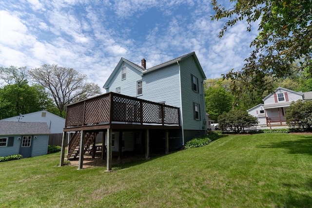 rear view of house featuring stairway, a wooden deck, a chimney, and an outdoor structure