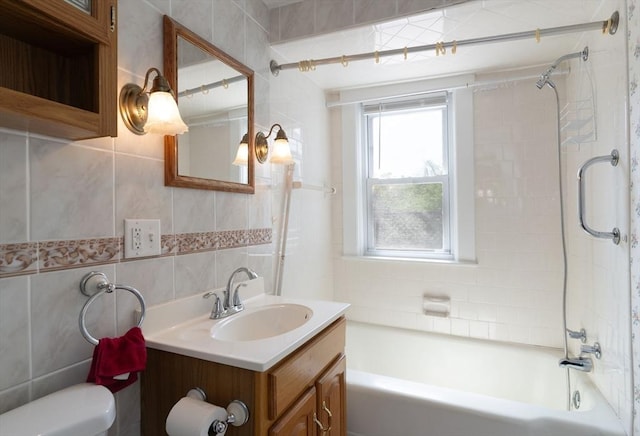 full bathroom with tile walls, toilet, vanity, washtub / shower combination, and decorative backsplash