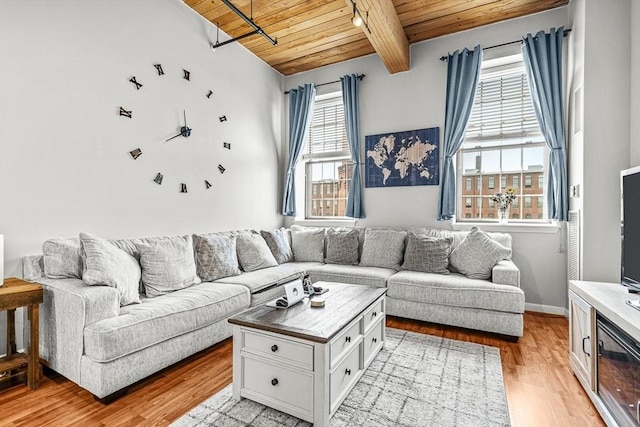 living room with light wood-style floors, wooden ceiling, and beamed ceiling