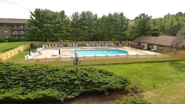 view of swimming pool with a patio area and a lawn